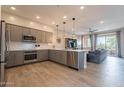 Open concept kitchen with modern appliances, a large island, and a spacious adjacent living room at 250 W Queen Creek Rd # 206, Chandler, AZ 85248