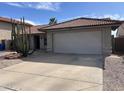 Single story home with desert landscaping and a two car garage at 2705 E Rock Wren Rd, Phoenix, AZ 85048