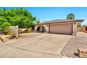 Charming single-story home showcasing a brick facade, a spacious driveway, and mature trees in a well-maintained yard at 2741 S Brooks --, Mesa, AZ 85202