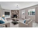 Bright living room featuring a stone fireplace, neutral decor, and tile flooring, perfect for comfortable living at 2741 S Brooks --, Mesa, AZ 85202