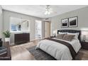Serene main bedroom boasting ample natural light, a ceiling fan, and ensuite bathroom at 2741 S Brooks --, Mesa, AZ 85202