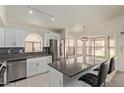 Modern kitchen featuring stainless steel appliances, white cabinetry, and a breakfast bar at 2904 E Ludlow Dr, Phoenix, AZ 85032