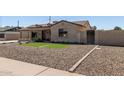 Attractive home featuring easy-care desert rock landscaping and a welcoming front entrance at 3301 E Sharon Dr, Phoenix, AZ 85032