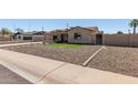 Attractive home with low maintenance desert rock landscaping and a cozy, welcoming entrance at 3301 E Sharon Dr, Phoenix, AZ 85032