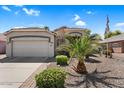 Inviting single-story home featuring a spacious driveway, desert landscape, and well-kept lawn at 3443 E Thornton Ave, Gilbert, AZ 85297