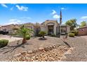 Charming single-story home with desert landscaping, palm trees and a welcoming facade at 3443 E Thornton Ave, Gilbert, AZ 85297