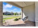 Inviting front porch features a hanging swing, brick flooring and lovely neighborhood views at 3648 E Arabian Dr, Gilbert, AZ 85296