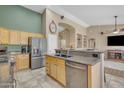 Well-lit kitchen featuring stainless steel appliances, tile floors, and granite countertops at 3841 E Redfield Ct, Gilbert, AZ 85234