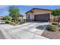 Attractive home with a two-car garage, desert landscaping, and a sidewalk leading to the entrance at 4027 W Copperleaf Dr, San Tan Valley, AZ 85144