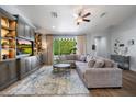 Comfortable living room with an oversized sectional sofa and an elegant built-in entertainment center at 4110 E Indianola Ave, Phoenix, AZ 85018