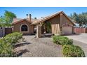 Charming home featuring a covered porch, flag and desert-friendly landscaping in the front yard at 421 E Terrace Ave, Gilbert, AZ 85234