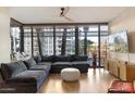 Bright living room with a large sectional, floor-to-ceiling windows, and a view of the city at 4808 N 24Th St # 303, Phoenix, AZ 85016