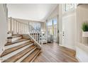 Inviting entryway with wood floors, staircase, and a large arched window at 721 W Mountain Sky Ave, Phoenix, AZ 85045