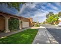 Side view of charming single-story home with manicured lawn and sidewalk at 7807 E Granada Rd, Scottsdale, AZ 85257