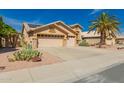 Single-Gathering home with a three-car garage and desert landscaping at 8402 W Laurel Ln, Peoria, AZ 85345
