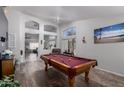 Spacious game room featuring a classic pool table and wood flooring at 8402 W Laurel Ln, Peoria, AZ 85345