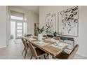 Light and airy dining room featuring a wooden table, modern chairs, and decorative art on the walls at 9442 N 118Th St, Scottsdale, AZ 85259