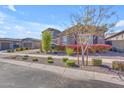 Charming two-story home featuring manicured landscaping with trees, shrubs, and gravel beds at 9942 E Rotation Dr, Mesa, AZ 85212