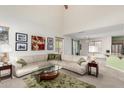 Open-concept living room featuring a plush sectional sofa, modern decor, and seamless transition to the kitchen at 1101 S Hazel St, Gilbert, AZ 85296
