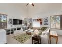 Bright and airy living room with vaulted ceilings, a cozy sofa, and ample natural light from large windows at 1101 S Hazel St, Gilbert, AZ 85296