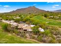 Desert home boasts a red tile roof, desert landscaping, and mountain views at 1637 N Quartz Valley Rd, Scottsdale, AZ 85266