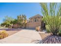 Tan two-story home featuring a balcony above the garage and xeriscaped front yard at 2317 E Desert Cove Ave, Phoenix, AZ 85028