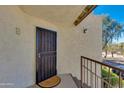 Inviting front entrance featuring a secure gate, textured walls, and a charming welcome mat at 10444 N 69Th St # 224, Paradise Valley, AZ 85253