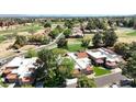 An aerial view reveals residences with terracotta roofs alongside a golf course and tree-lined streets at 11837 N 40Th Pl, Phoenix, AZ 85028