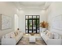 Contemporary living room with bright neutral colors, modern decor, and a large window view at 12055 E Clinton St, Scottsdale, AZ 85259