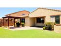 Private backyard featuring a charming pergola, green synthetic grass, and a serene outdoor space perfect for relaxation at 1437 E Flamingo Way, Gilbert, AZ 85297
