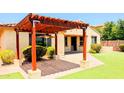 Wonderful backyard pergola over a patio, creating a relaxing outdoor area with low-maintenance synthetic grass at 1437 E Flamingo Way, Gilbert, AZ 85297