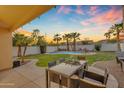 Scenic backyard with dining area overlooking the pool and well-maintained desert landscaping at 15206 S 47Th St, Phoenix, AZ 85044