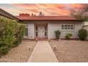 Inviting home facade with a walkway leading to the front door, and garden lighting at 1523 W Glenn Dr, Phoenix, AZ 85021