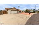 Exterior shot of a well-maintained single-story home with a two-car garage and desert landscaping at 16010 N 47Th Dr, Glendale, AZ 85306