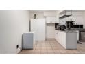 Bright eat-in kitchen with ample counter space, white cabinets, and neutral flooring at 1818 S Toltec --, Mesa, AZ 85204