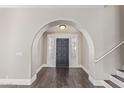 Stunning entryway with dark wood floors, a modern light fixture and gray entry door at 2257 E Lockwood St, Mesa, AZ 85213