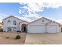 Inviting single-Gathering home featuring an attached three-car garage and desert landscaping at 2257 E Lockwood St, Mesa, AZ 85213