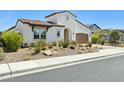 Charming single-Gathering home with a well-kept xeriscaped front yard, neutral tones, and a two-car garage at 22743 N 97Th Dr, Peoria, AZ 85383