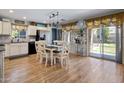 Dining area with wood floors, a chandelier, and lots of natural light at 23945 N Pablo N Ct, Sun City, AZ 85373