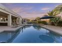 Sparkling pool and covered patio provide an ideal space for outdoor relaxation and entertainment at 24695 S 195Th Way, Queen Creek, AZ 85142