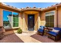 Inviting front courtyard with seating, tiled floors, and views of the lush greenery outside at 25862 N 108Th Ave, Peoria, AZ 85383