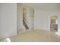 Open living space with tile floors, arched doorways, and view of the stairs and kitchen at 2806 E Pontiac Dr, Phoenix, AZ 85050
