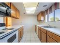 Well lit kitchen with white appliances, neutral countertop and wood cabinets at 3031 N Civic Center Plz # 255, Scottsdale, AZ 85251