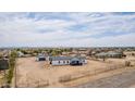 Expansive property featuring a single-story home, detached garage, and ample yard space with fencing at 30433 W Bellview St, Buckeye, AZ 85396