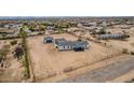 Wide aerial view of a property with detached garage, home, large yard, and fencing at 30433 W Bellview St, Buckeye, AZ 85396