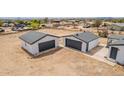 Two modern detached garages with sleek gray doors and white siding, on a large lot at 30433 W Bellview St, Buckeye, AZ 85396