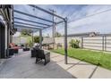Charming backyard featuring a pergola-covered patio, artificial turf, and a desert landscape along the fence at 3246 E Palm Ln, Phoenix, AZ 85008