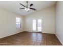 Bright living room with tile flooring, ceiling fan and sliding glass door to the backyard at 3323 W Fraktur Rd, Phoenix, AZ 85041