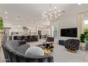 Bright, open-concept living room and kitchen with modern lighting and stylish furniture at 340 E Osborn Rd # 3, Phoenix, AZ 85012