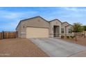 Beautiful single-story home boasts a large driveway and low maintenance desert landscaping at 3818 N 306Th Ave, Buckeye, AZ 85396